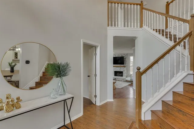 a view of entryway and hall with wooden floor