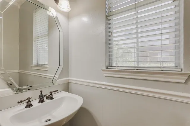 a bathroom with a sink and a window