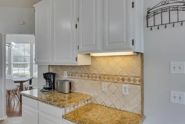a kitchen with granite countertop white cabinets and a granite counter tops