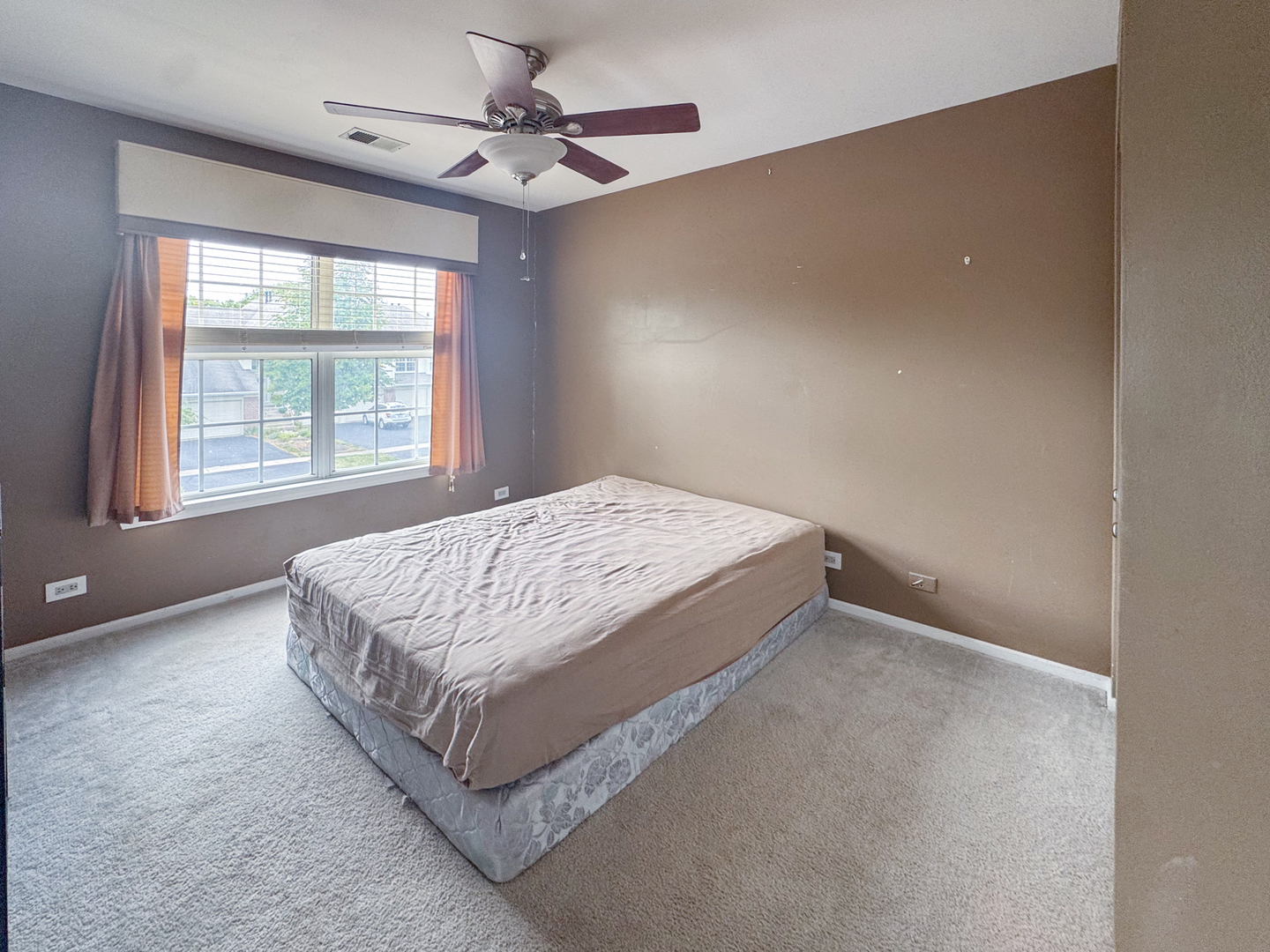 30-w015 Juniper Court, Unit 30W015 Warrenville, IL 60555 - Photo 10 of 14 a bed sitting in a bedroom next to a window