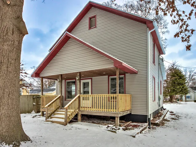 a view of a house with a patio and wooden fence