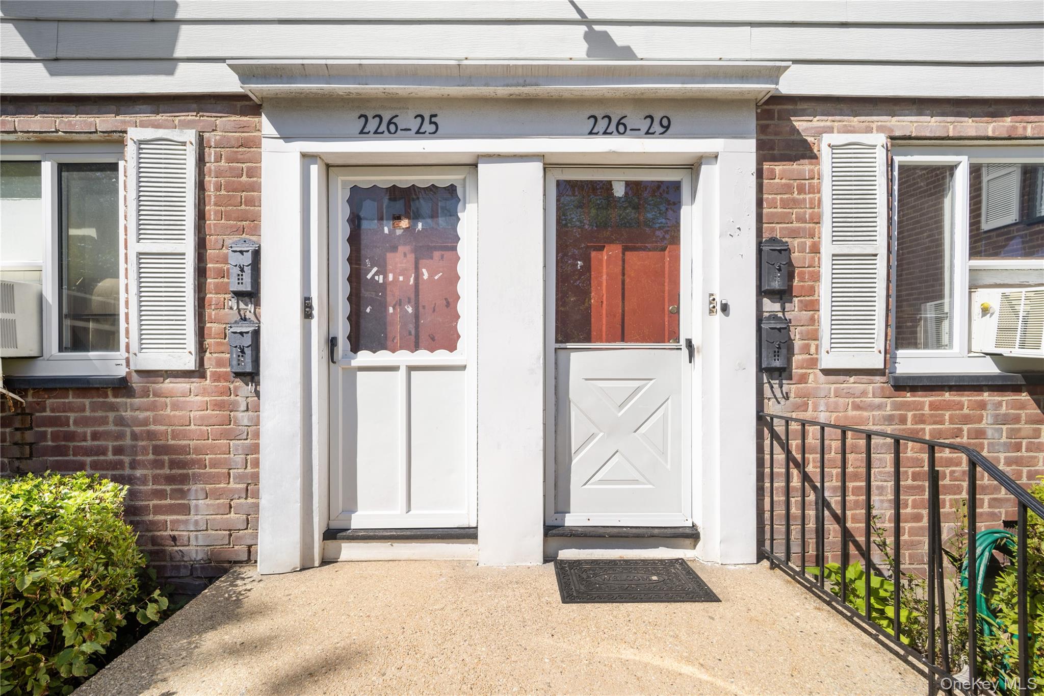 226-29 Manor Road, Unit UPPR Queens, NY 11427 - Photo 1 of 21 View of exterior entry with brick siding