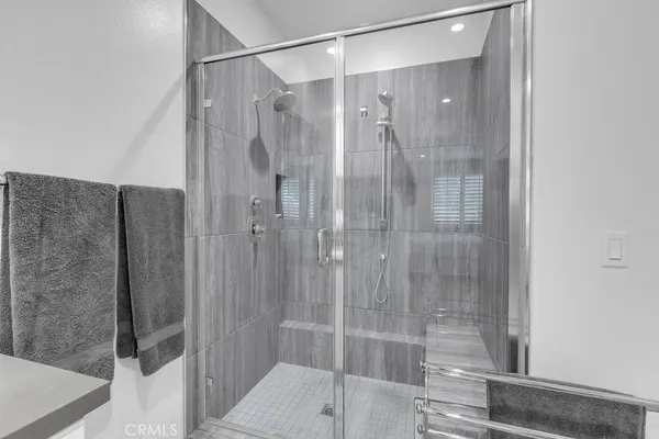a bathroom with a shower and a sink