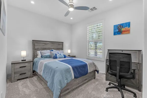 a bed room with a bed and a chair