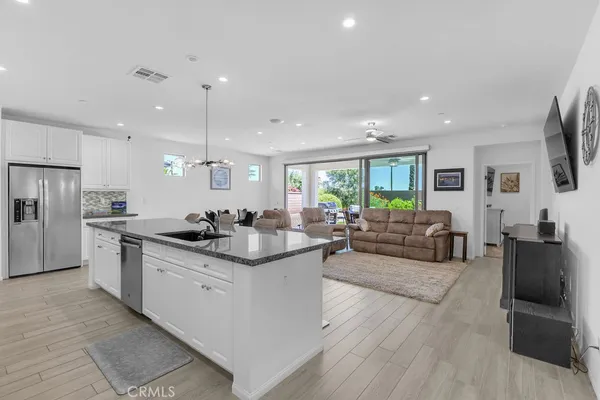 a kitchen with counter top space a sink appliances and cabinets