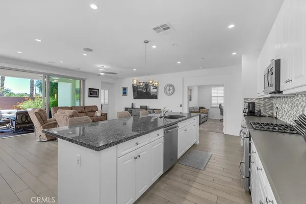 a large kitchen with a large counter top appliances and cabinets