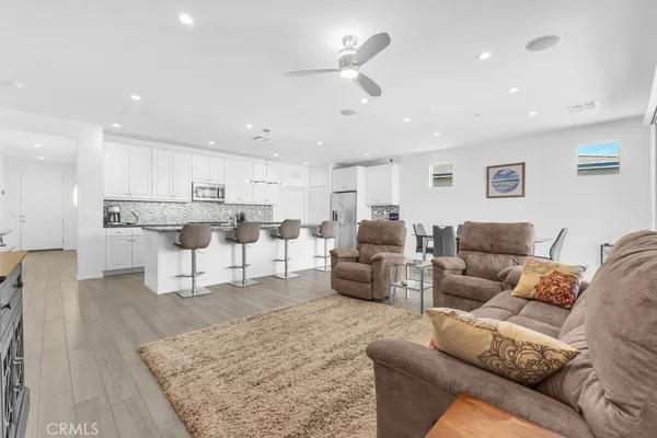a living room with furniture and kitchen view