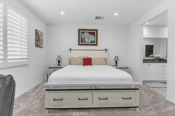 a bedroom with a bed and a tv