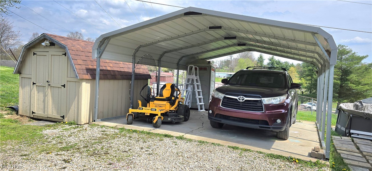 570 Timber Run Road Zanesville, OH 43701 - Photo 4 of 34 View of car parking featuring a detached carport and a shed