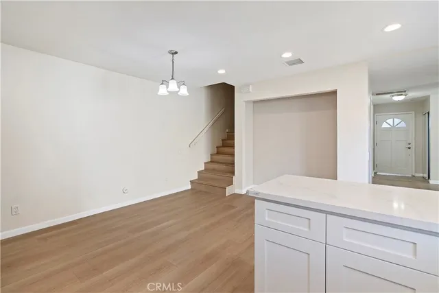 a view of a room with wooden floor and staircase