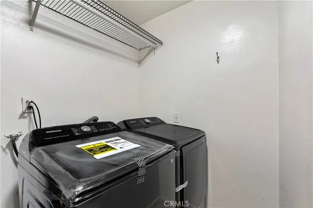 a view of an empty room with wooden floor and closet