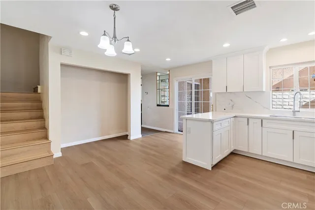 a kitchen with white cabinets and center island