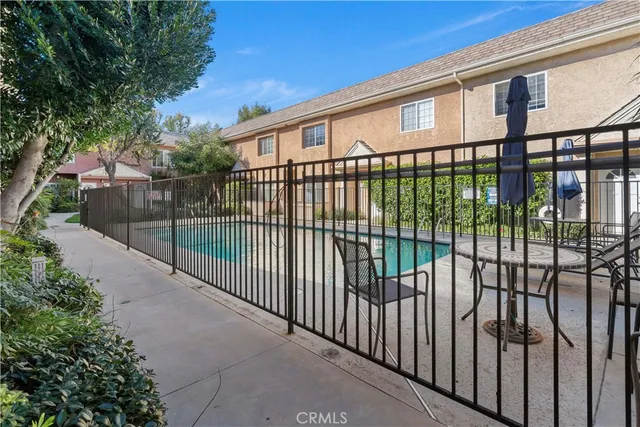 a view of a chairs and table in the backyard