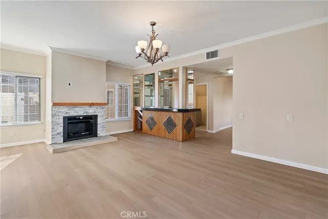 a view of a livingroom with a fireplace and chandelier fan