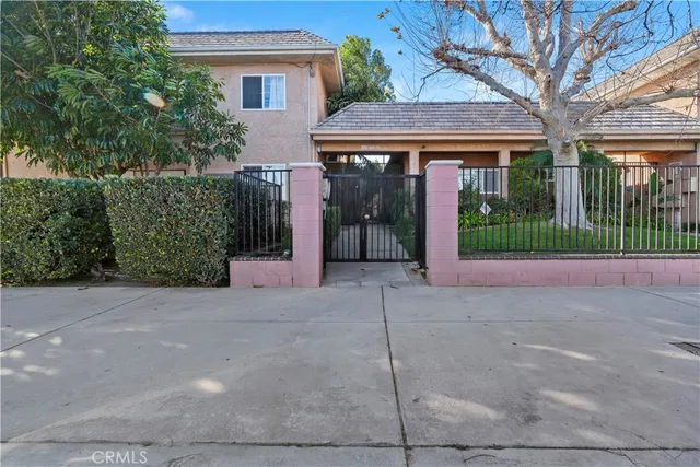 a view of a house with a small yard and plants