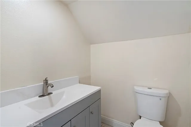 a bathroom with a sink a toilet and mirror