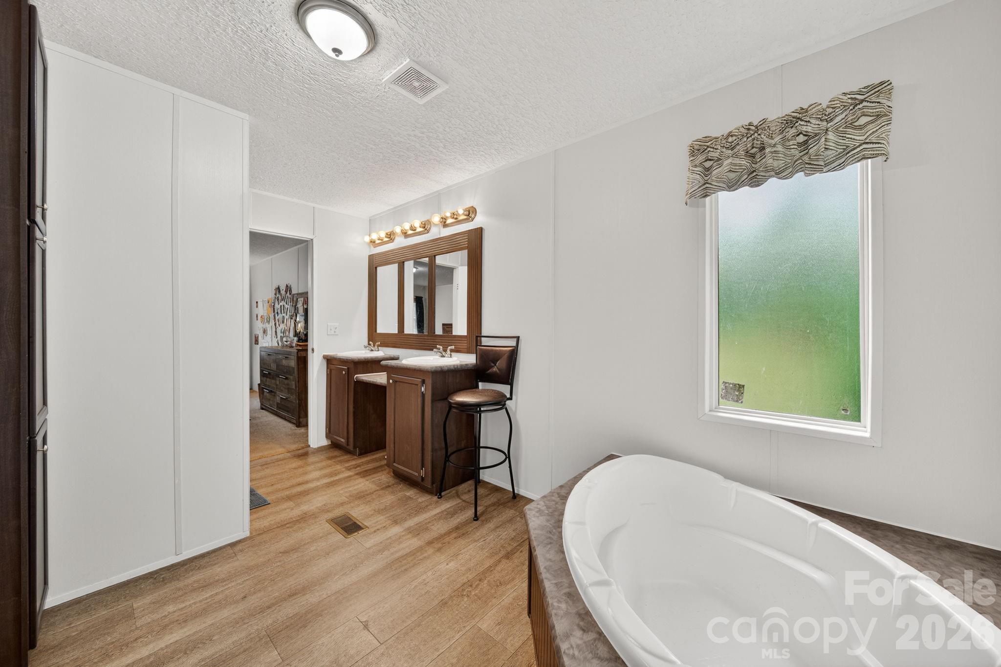 6956 Jamestowne Road Lancaster, SC 29720 - Photo 13 of 36 a spacious bathroom with a bathtub sink and mirror