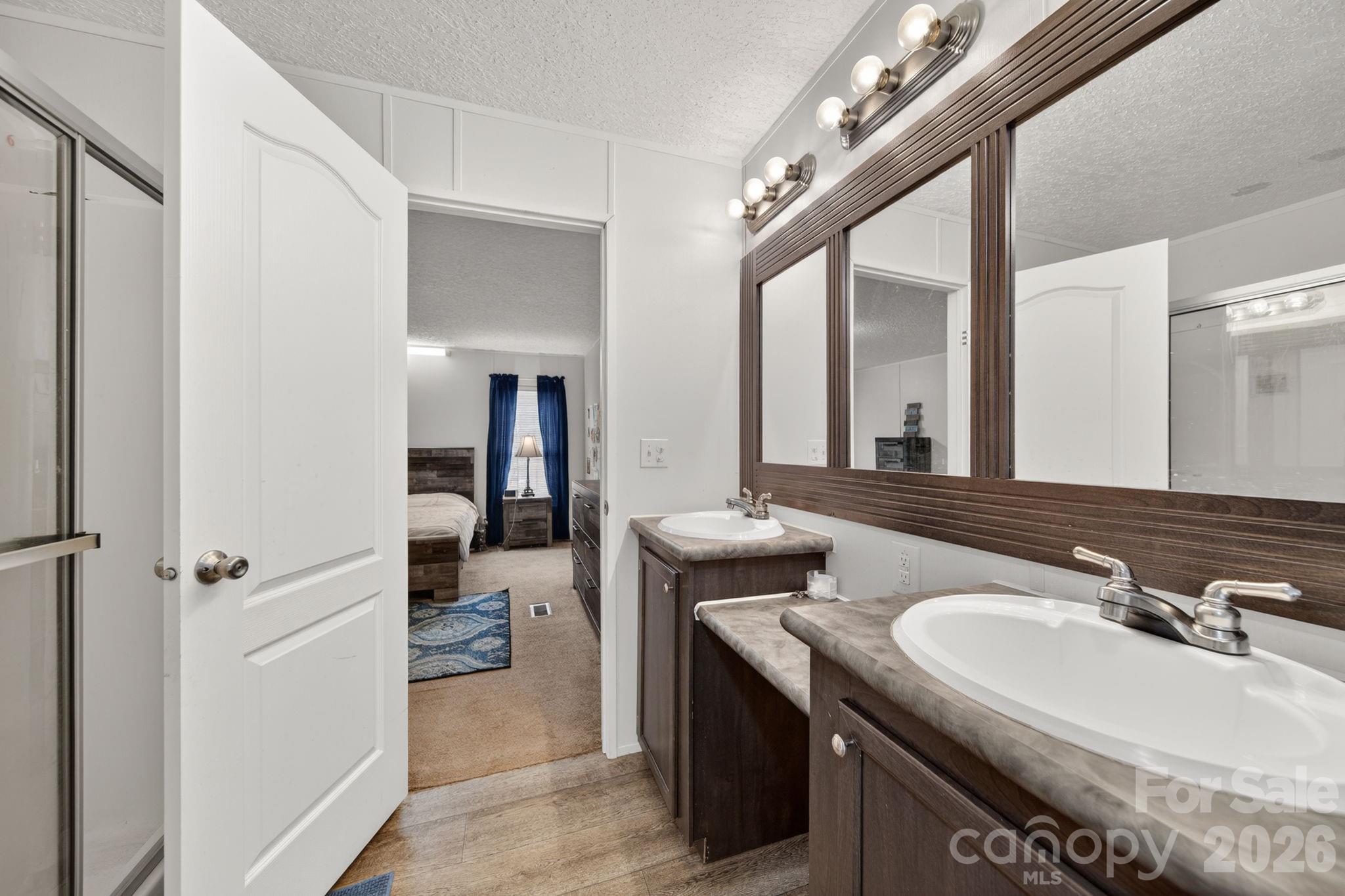 6956 Jamestowne Road Lancaster, SC 29720 - Photo 14 of 36 a en suite bathroom with a sink and a mirror