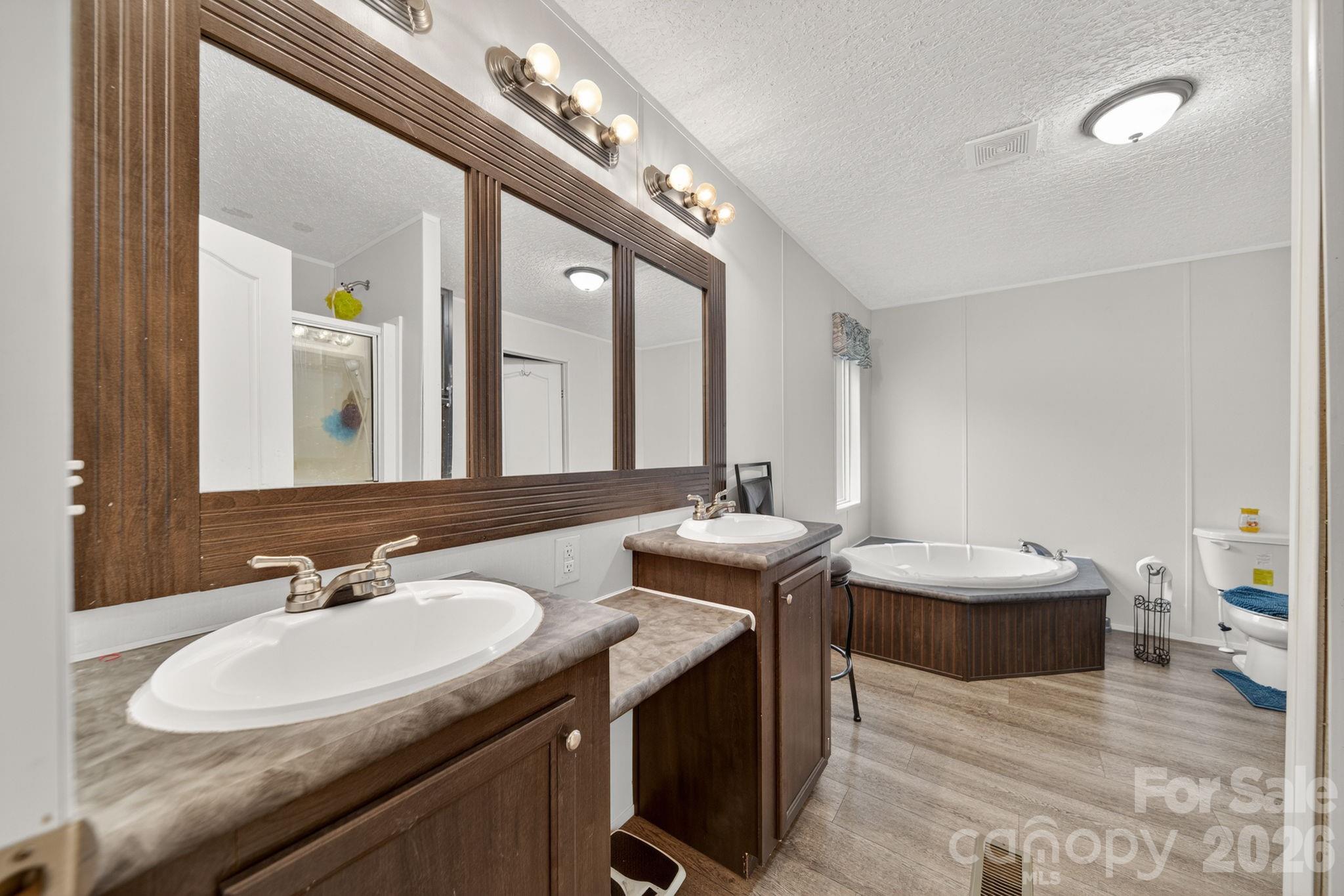 6956 Jamestowne Road Lancaster, SC 29720 - Photo 15 of 36 a en suite bathroom with a double vanity sink and a mirror