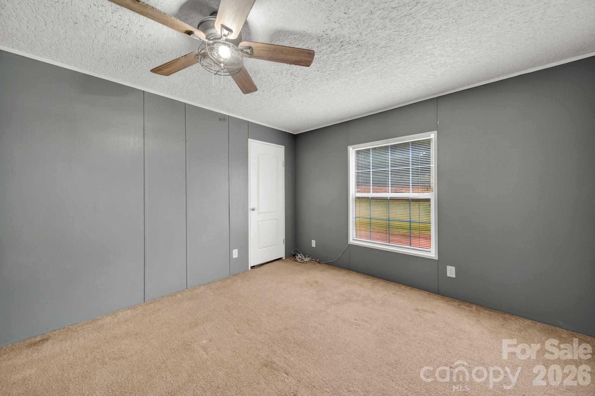 6956 Jamestowne Road Lancaster, SC 29720 - Photo 22 of 36 an empty room with windows and fan