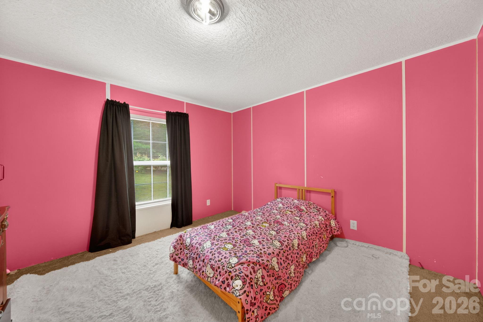 6956 Jamestowne Road Lancaster, SC 29720 - Photo 23 of 36 a bedroom with a bed and a large window
