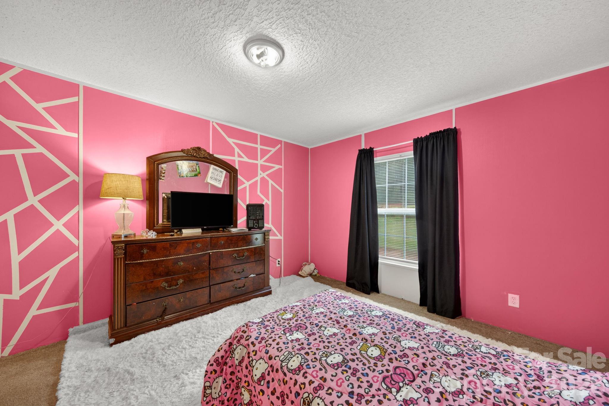 6956 Jamestowne Road Lancaster, SC 29720 - Photo 24 of 36 a bedroom with a bed and a dresser