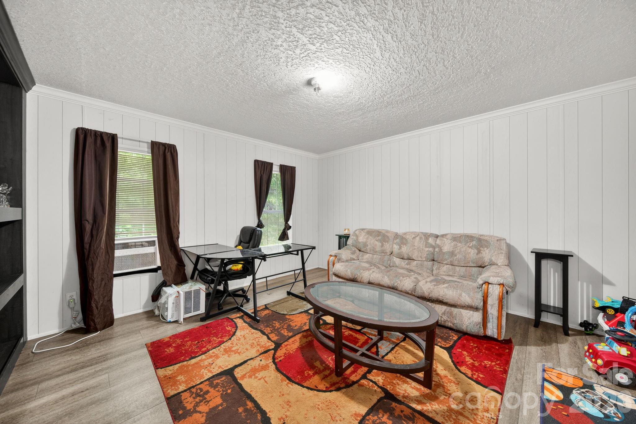 6956 Jamestowne Road Lancaster, SC 29720 - Photo 26 of 36 a living room with furniture and a floor to ceiling window