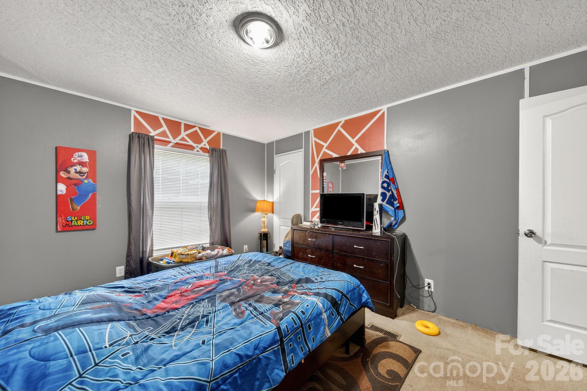 6956 Jamestowne Road Lancaster, SC 29720 - Photo 29 of 36 a bedroom with a bed and a flat screen tv
