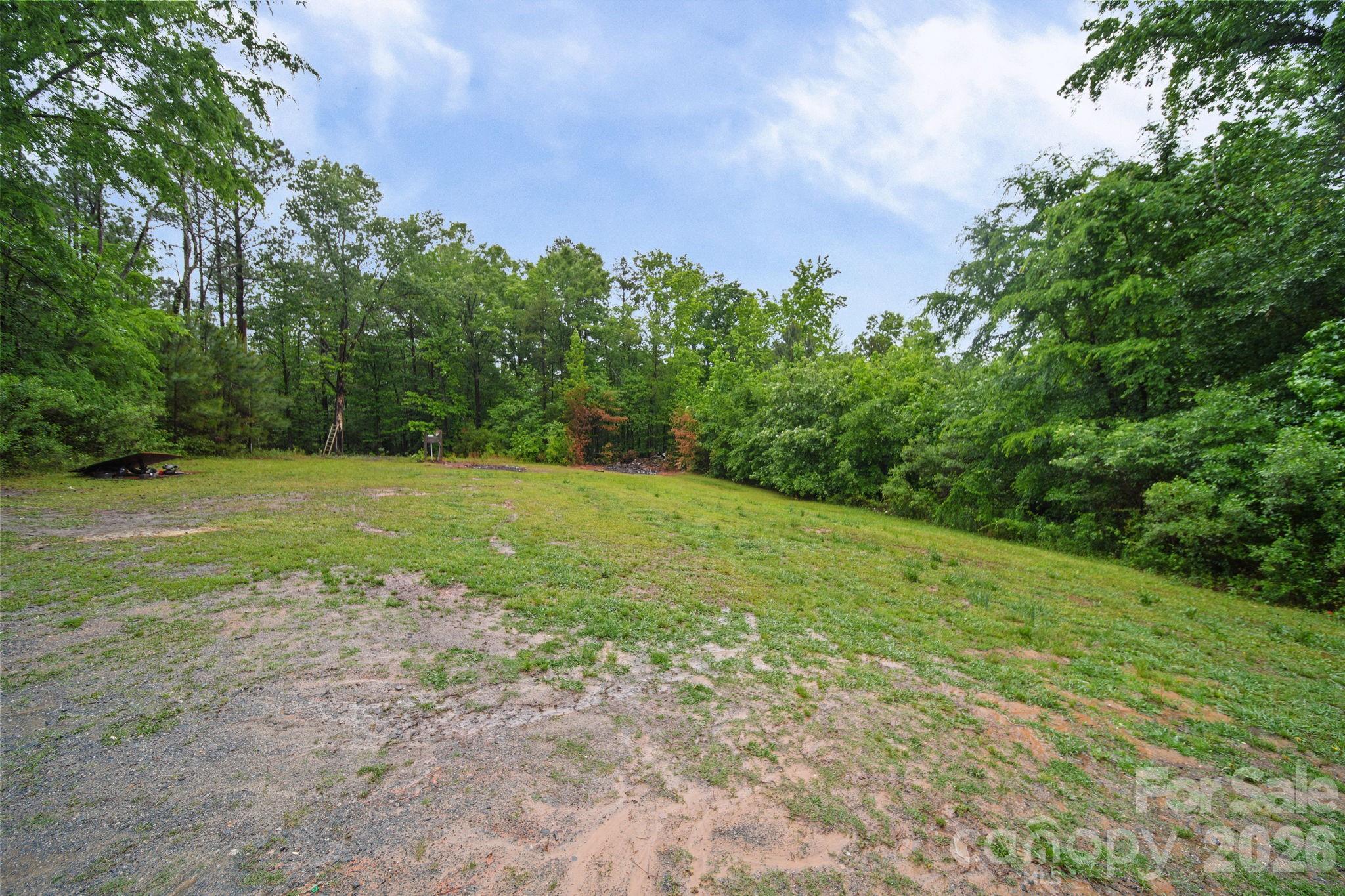 6956 Jamestowne Road Lancaster, SC 29720 - Photo 36 of 36 a view of a field with an trees in front of it