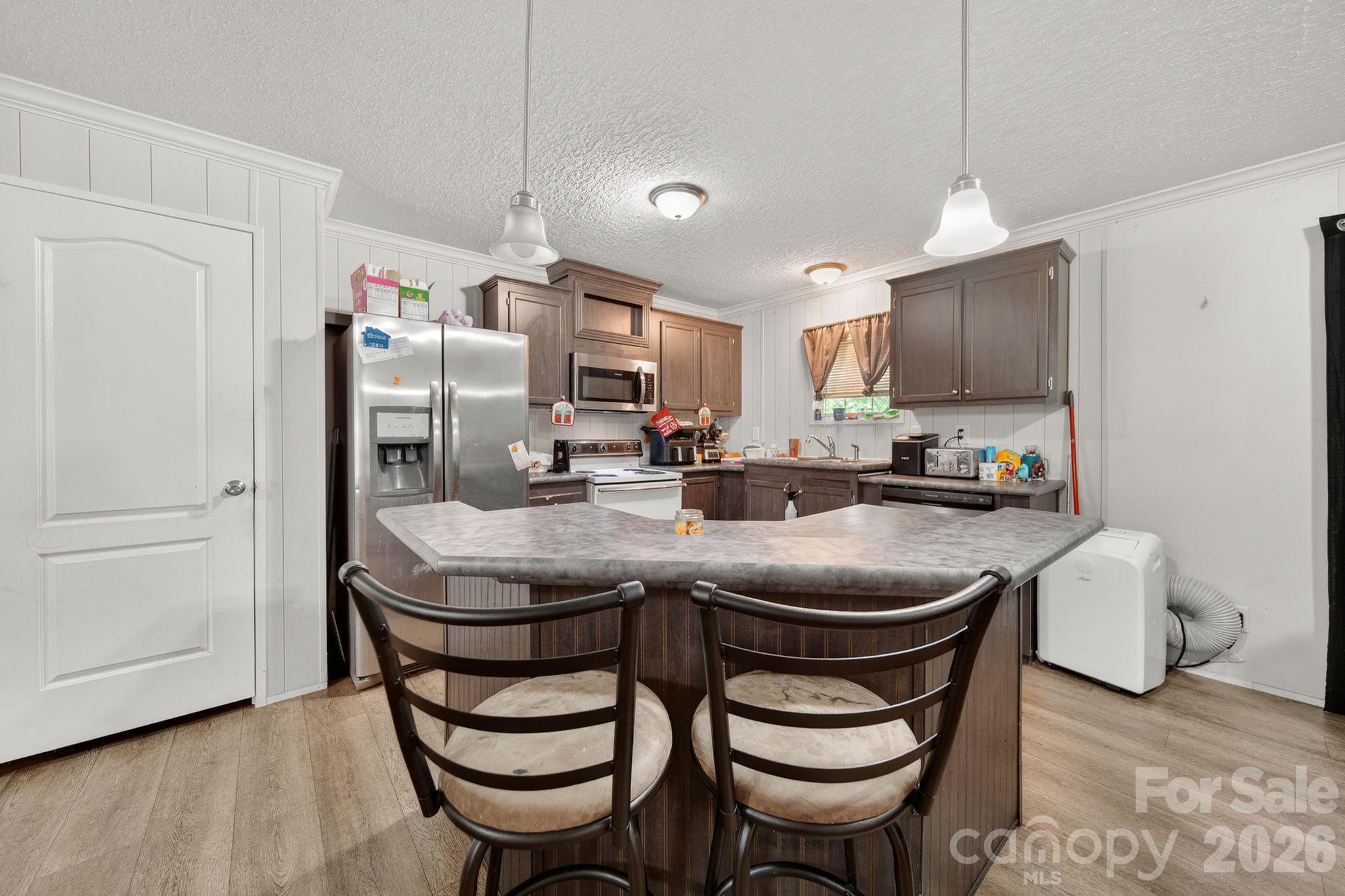 6956 Jamestowne Road Lancaster, SC 29720 - Photo 7 of 36 a kitchen with stainless steel appliances granite countertop a sink a stove a refrigerator and cabinets