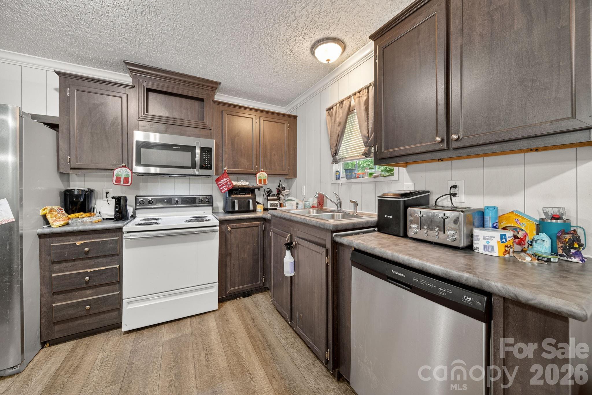 6956 Jamestowne Road Lancaster, SC 29720 - Photo 8 of 36 a kitchen with stainless steel appliances granite countertop a sink dishwasher stove and cabinets