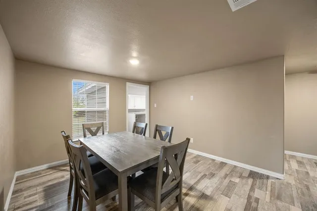 a view of a dining room with furniture and window