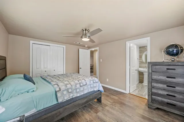 a bedroom with a bed and a view of closet