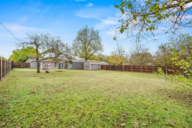 a view of a yard with a house in the background