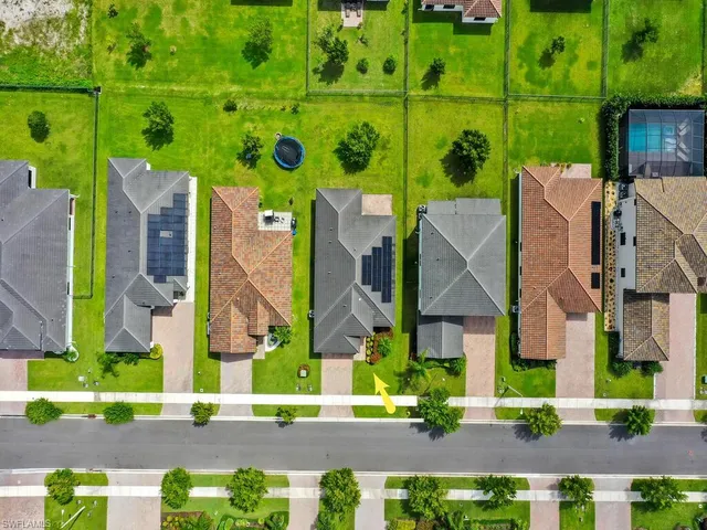 an aerial view of houses with outdoor space and street view