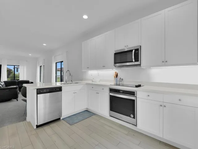 a room with lots of furniture and a wooden floor