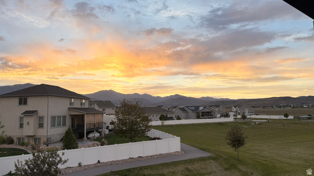 7889 Bristlecone Road Eagle Mountain, UT 84005 - Photo 3 of 42 Property with a neutral-toned stucco exterior featuring a dark roof and multiple windows