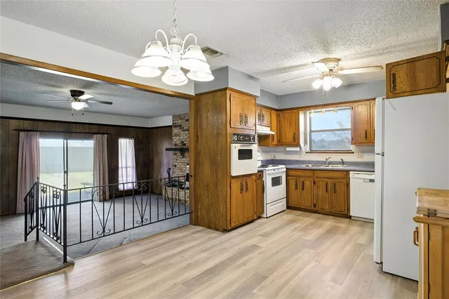 a kitchen with refrigerator and cabinets