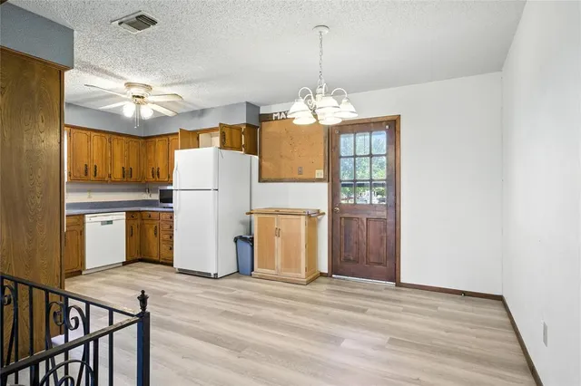 a view of a kitchen with refrigerator and microwave