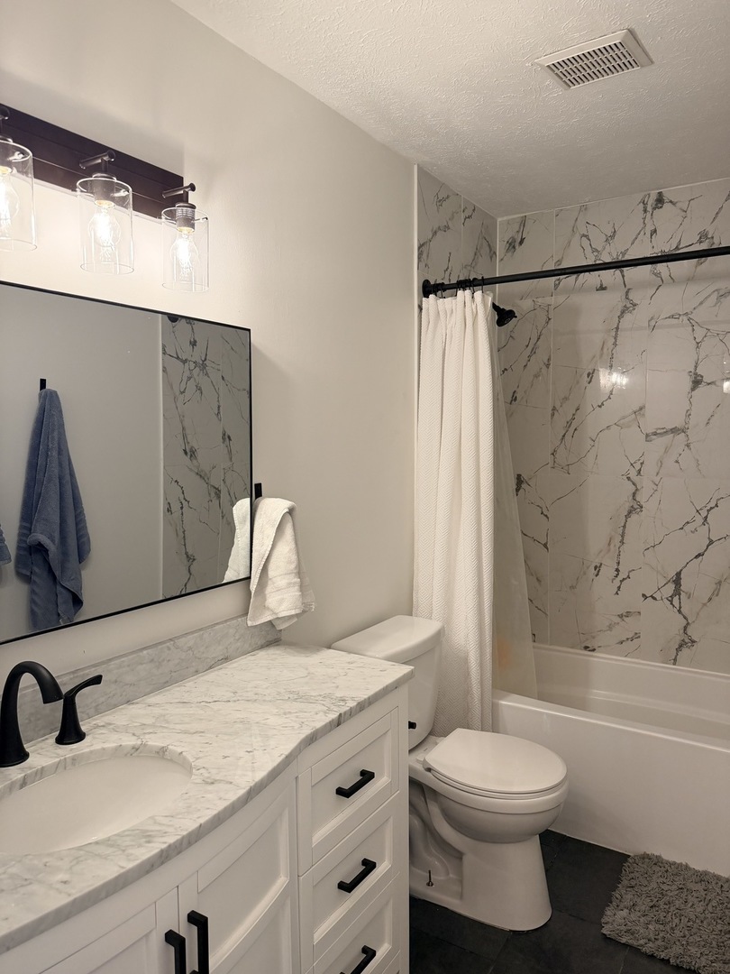 903 North Linden Street, Unit 28 Normal, IL 61761 - Photo 11 of 18 a bathroom with a granite countertop sink toilet and shower
