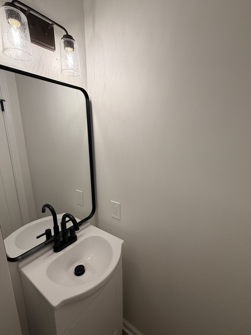903 North Linden Street, Unit 28 Normal, IL 61761 - Photo 15 of 18 a bathroom with a sink and mirror