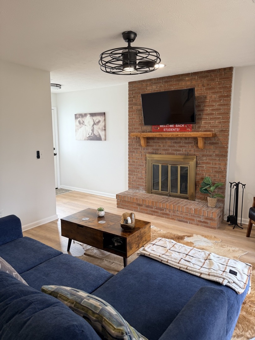 903 North Linden Street, Unit 28 Normal, IL 61761 - Photo 3 of 18 a living room with furniture and a fireplace