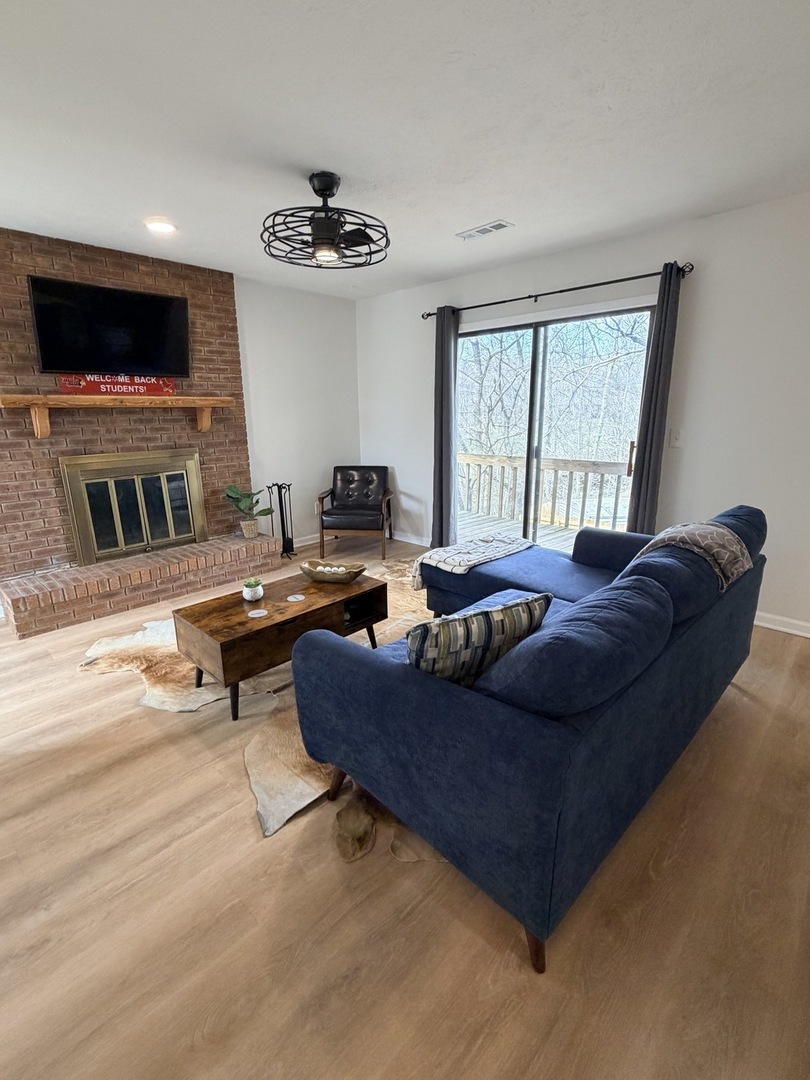 903 North Linden Street, Unit 28 Normal, IL 61761 - Photo 4 of 18 a living room with furniture and a flat screen tv