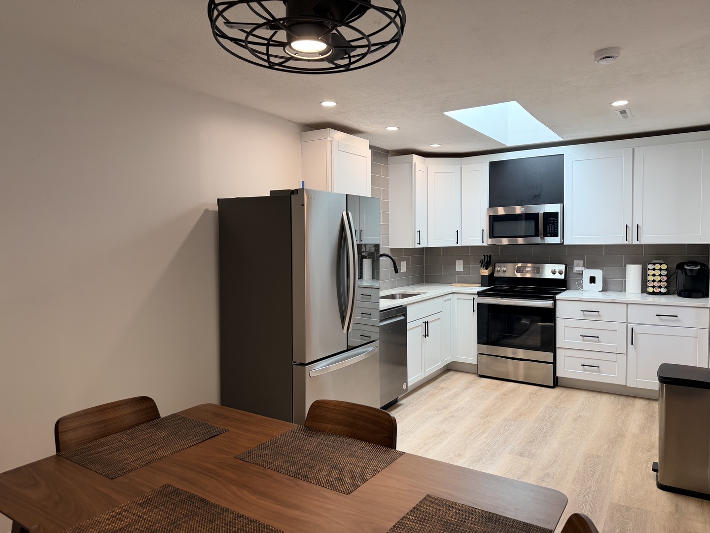 903 North Linden Street, Unit 28 Normal, IL 61761 - Photo 6 of 18 a kitchen with granite countertop a refrigerator stove and microwave