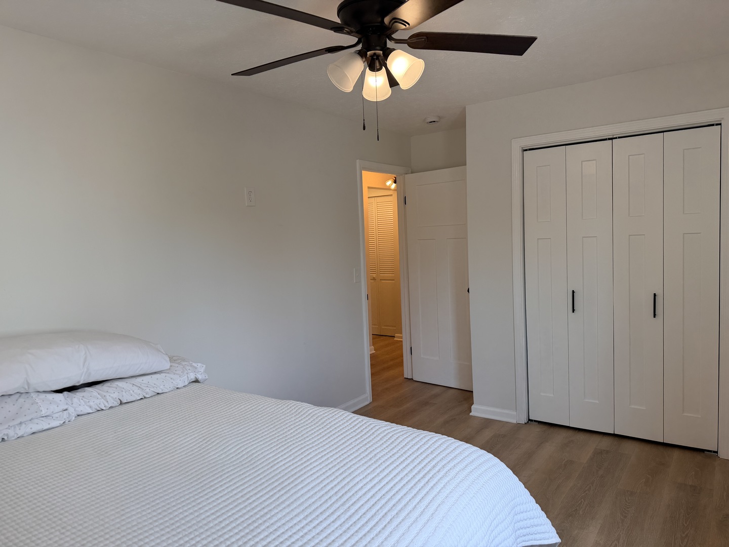 903 North Linden Street, Unit 28 Normal, IL 61761 - Photo 10 of 18 a bedroom with a bed and a chandelier