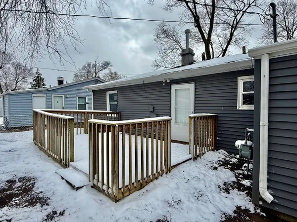 a view of a house with a wooden fence