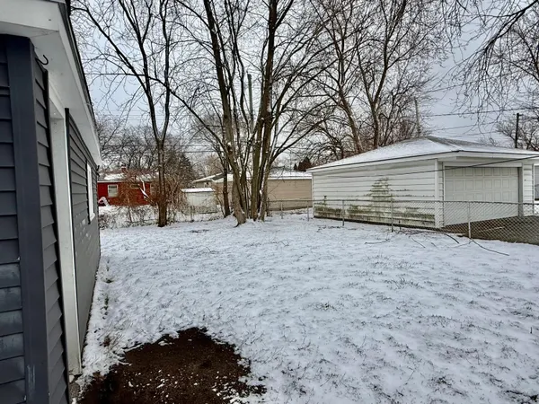 a view of a yard covered in snow