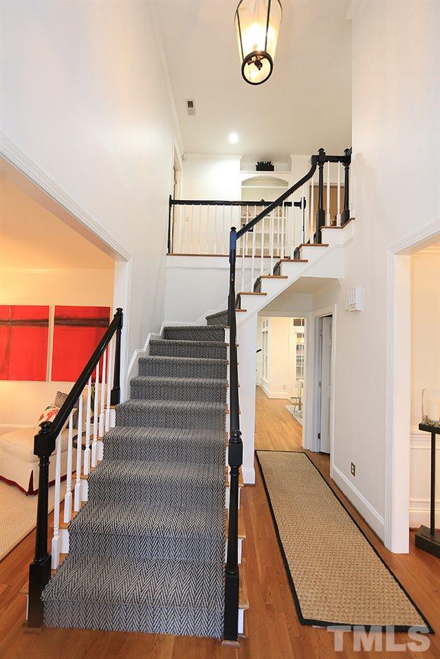 5208 Strathmore Drive Raleigh, NC 27613 - Photo 5 of 30 Carpeted stairs for safety, beautiful chandelier