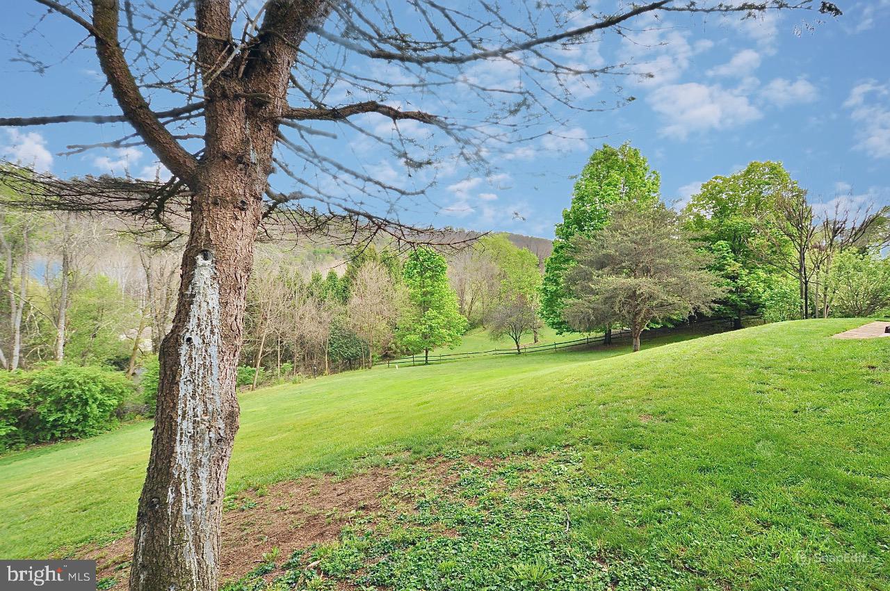 9717 Frazier Crest Huntingdon, PA 16652 - Photo 26 of 27 Lush green landscape under blue skies.