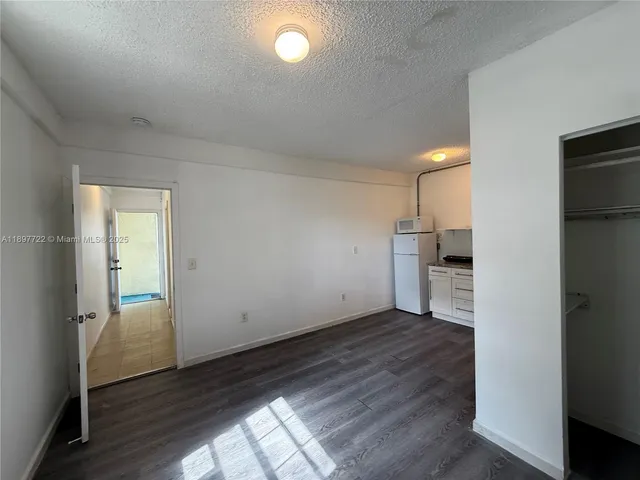 a view of a kitchen with a sink and dishwasher wooden floor